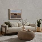 Ella Sofa styled in a neutral modern room with round woven coffee table and wall art