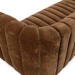 Close-up on corner stitching and velvet fabric showing the sofa’s soft texture and craft detail