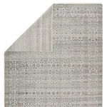 Rug partially folded over to reveal soft gray woven backing and thin pile height