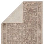 Another view of rug corner flipped to reveal lighter backside with faint pattern