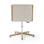 Carla Desk Chair in camel upholstery at cream wood desk against wood paneled wall