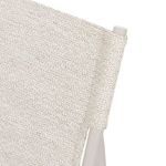 Close-up of woven fabric backrest covering aluminum tubes on chair’s upper frame