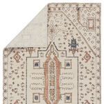 Backside corner of the rug flipped to reveal the woven backing and edge binding details