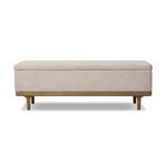 Spacious rectangular trunk with cream textured fabric upholstery and worn oak frame and tapered legs