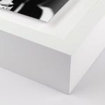 Close-up of thick white frame corner and white mat edges