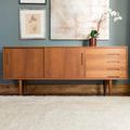 Ivory shag rug in a styled room setting underneath mid-century wooden sideboard