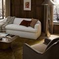 Side view of the lamp by window with snowy outdoor scene and surrounding modern furniture