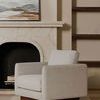 Vernon chair in living room setting with stone fireplace and art on mantel