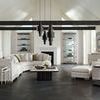 Modern room interior showcasing chair styled with two nested end tables and pendant lighting