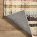 Rug folded corner flipped revealing tightly woven gray backing