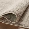 Close-up of folded rug revealing backside woven construction and thickness