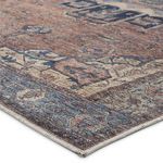 Close-up angle showing texture and edge binding of the Barrymore blue and dark brown rug
