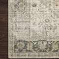 Detailed close-up of the Skye Natural Sand Rug corner showing floral border on dark wood floor