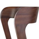 Close-up on backrest’s curved walnut panels showing rich wood grain and seamless joints