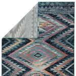 Back side of rug with corner folded to reveal white and light gray woven structure