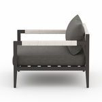 Side profile highlighting thick seat cushion and rope-wrapped armrest detail