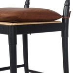 Close-up of midsection showing wood grain texture and leather cushion edge on Fayth Bar + Counter Stool