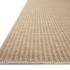 Low angle close-up of rug corner highlighting whip-stitched edge and vertical stripes
