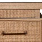 Close-up of drawer front showing rattan weave and elongated antique bronze handle