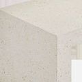 Close-up of bench corner highlighting ivory terrazzo surface with speckled tempered glass pieces
