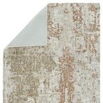 Rug partially folded to reveal solid light grey rug backing
