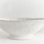 Side close-up highlighting the bowl’s footed base and textured ceramic surface