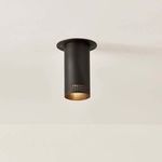 Ceiling-mounted bronze Berg Flush Mount emitting warm light from inside perforated cylindrical shade
