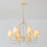 Warrensburg chandelier illuminated, showing warm glow through linen lampshades