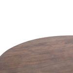 Angled close-up of tabletop edge and iron base highlighting wood grain and metal finish