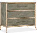 Two-tone Retreat Pole Rattan chest with sand-colored frame and seagrass green drawer fronts, featuring three textured bar ...
