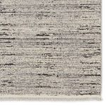 close-up of distressed striped pattern and stitched cream edge