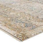 Close-up corner view showing texture and muted color blending of the rug's gray, cream, and gold fibers