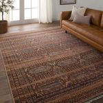 Leone rug styled in bright living room with tan leather sofa and hardwood flooring