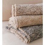 Side view of stacked Brentwood Throws highlighting thick textured fabric and fringed trim