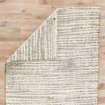 Back side of rug showing reversed diagonal pattern in white and black jute fibers