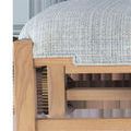 Close-up of the bench corner showing stepped detail of greenlight upholstery meeting ash wood frame