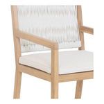 Close-up of armrest and cushion with visible texture of synthetic wicker and teak wood grain