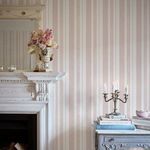 Wallpaper displayed on wall behind decorative mantel and candelabra, styled in a cozy interior setting