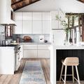 Runner version of Layla rug in kitchen with white cabinets, wooden ceiling, and tall wooden stool