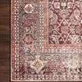 Detailed close-up of the rug’s intricate border pattern with cinnamon, sage, and cream tones