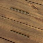 Wood grain and panel detail on dresser drawer fronts with subtle color variation