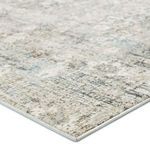 Close-up view of rug edge showing lustrous sheen and color blend of ivory, gray, blue, and green
