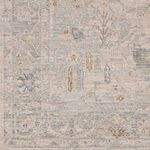Close-up of light gray woven rug showing detailed soft tonal patterns and texture