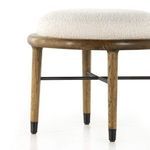 Close-up showing boucle upholstery curvature and interface with wooden ring frame