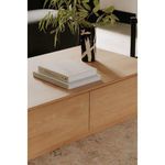 Close-up showing natural wood grain and drawer gap detail on Round Off Coffee Table with books and vase