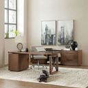 Wide view of the medium walnut Elon desk and pedestal in light office setting with artwork and rug