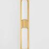 Wall sconce with unlit frosted glass mounted on grey wall, showing full front view with brass details