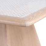 Close-up of the tabletop corner showing white rattan texture and light oak wood frame