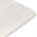 Close-up of the tabletop corner showing whitewash finish and subtle wood grain texture