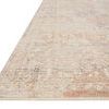 Faye rug angled view showing slim profile and detailed pattern with blended beige and blue hues.